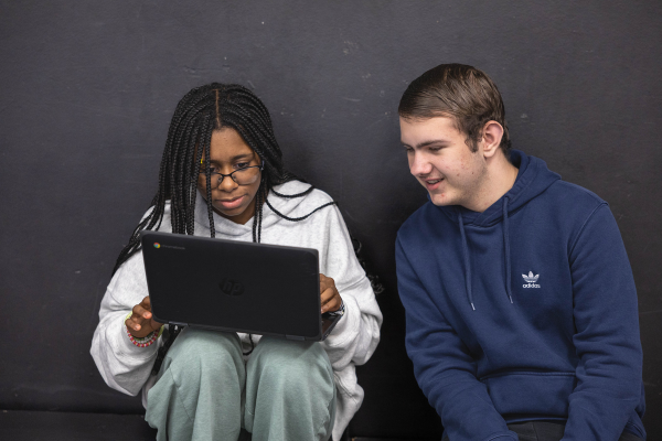  Two students work on a laptop
